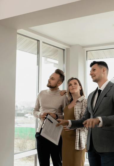 couple looking at house with realtor 1
